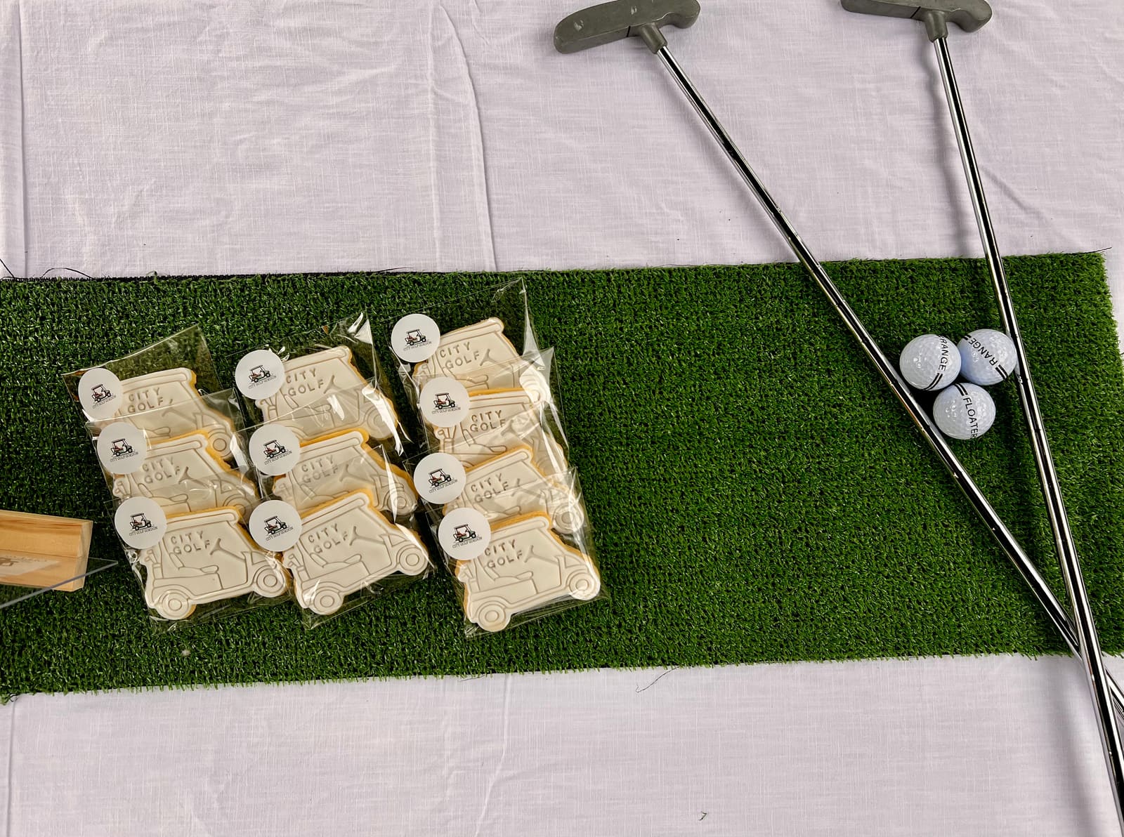 Branded City Golf Gordon cookies laid out with putters and golf balls