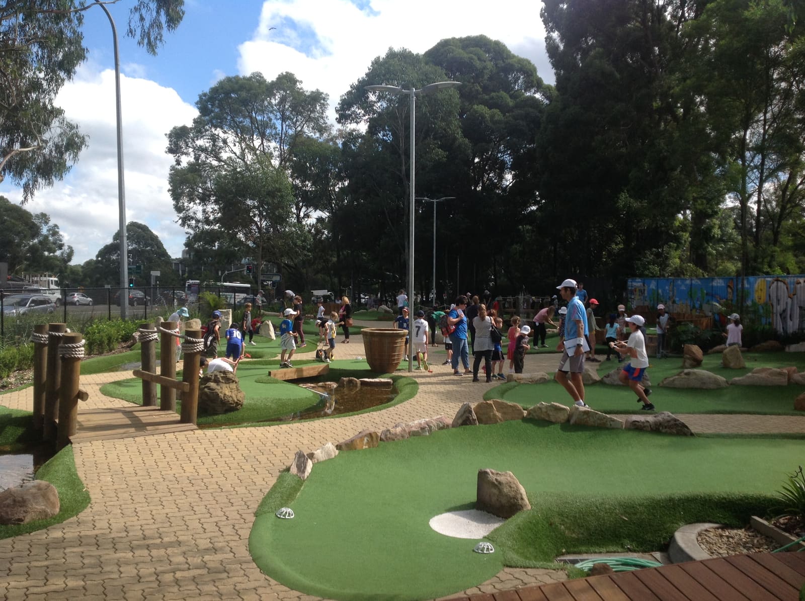 A large group of children playing mini golf at City Golf Gordon